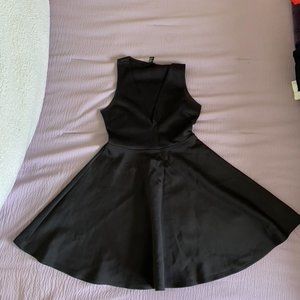 Black mini dress with deep V neck cut and flared skirt